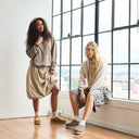 Model wearing BEARPAW Women's Calista Clog in a casual lifestyle setting, highlighting relaxed slip-on styling for everyday wear.