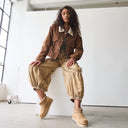 Close-up of BEARPAW Women's Langly Boot in Toffee worn on foot as part of a casual fall and winter outfit.