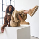 Model wearing BEARPAW Women's Langly Boot in Toffee with casual fall styling for an everyday cold-weather look.