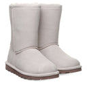 BEARPAW Women's Elle Short Boot in Winter White worn on foot with casual cold-weather styling for a cozy everyday look.
