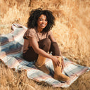 Model wearing BEARPAW Women's Elle Tall Boot in Iced Coffee with casual cold-weather styling for a cozy everyday look.