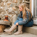 Model wearing BEARPAW Women's Elle Tall Boot in Mushroom with a casual fall outfit for cozy everyday cold-weather styling.