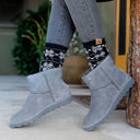 Close-up of BEARPAW Women's Alyssa Boot in Graphite worn on foot as part of a casual fall and winter outfit.