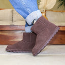 Close-up of BEARPAW Women's Alyssa Boot in Walnut worn on foot as part of a casual fall and winter outfit.