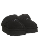 BEARPAW Women's Retro Loki Slipper in Black worn on foot with relaxed casual styling, highlighting cozy everyday comfort.