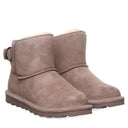 Close-up of BEARPAW Women's Betty Boot in Taupe Caviar worn on foot, highlighting the boot within a casual cold-weather outfit.