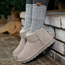 Model wearing BEARPAW Women's Shorty Boot in Mushroom with casual fall styling for a cozy everyday cold-weather look.