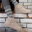 Close-up of BEARPAW Women's Shorty Boot in Mushroom worn on foot as part of a casual fall and winter outfit.
