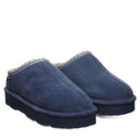 BEARPAW Women's Martis Vintage Clog in Indigo worn on foot with casual styling, highlighting the easy slip-on silhouette for everyday wear.