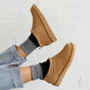 Model wearing BEARPAW Women's Super Shorty Boot in Iced Coffee with casual fall styling for a cozy everyday cold-weather look.