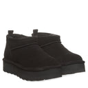 BEARPAW Women's Retro Super Shorty Boot in Black worn on foot with casual cold-weather styling for a cozy everyday look.