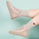 Close-up of BEARPAW Women's Winter Boot in Mushroom worn on foot, highlighting cozy cold-weather styling for everyday wear.