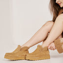 Close-up of BEARPAW Women's Maeve Platform Lo Boot in Iced Coffee Solid worn as part of a casual fall outfit.