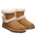 Close-up of BEARPAW Women's Kate Boot in Iced Coffee worn on foot, showing the boot as part of casual cold-weather styling.