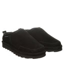 BEARPAW Men's Damian Clog in Black worn on foot with casual styling, highlighting the easy slip-on design for everyday comfort.