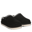 BEARPAW Women's Calista Clog in Black worn on foot with casual styling, highlighting the easy slip-on silhouette for everyday wear.