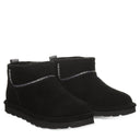 BEARPAW Women's Akira Boot in Black worn on foot with casual cold-weather styling, showing the boot in an everyday fall and winter look.