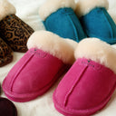 Model wearing BEARPAW Women's Loki II Slipper in Party Pink with relaxed casual styling for cozy everyday comfort.