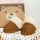 BEARPAW Youth Loki Slipper in Hickory worn in a relaxed lifestyle setting, styled for cozy everyday kids' comfort.