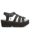 Side view of Bearpaw Delilah black raffia sandal with adjustable ankle strap and platform