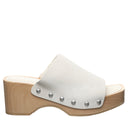 Side view of Bearpaw Tilda sandal in bleached sand showcasing suede upper, wooden block heel and slip-on mule silhouette